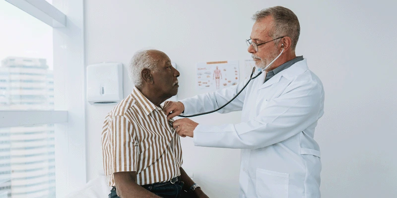 doctor checking patient's heart